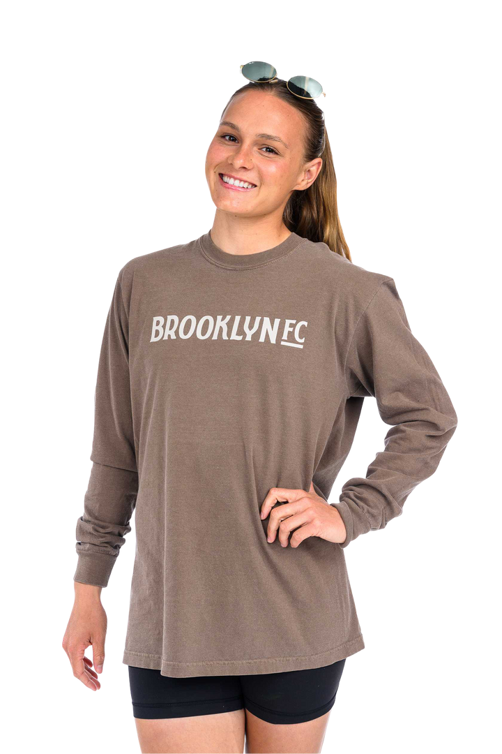 Brown long sleeve t-shirt with BROOKLYN FC logo in beige across the chest, unisex fit, and ribbed cuffs.