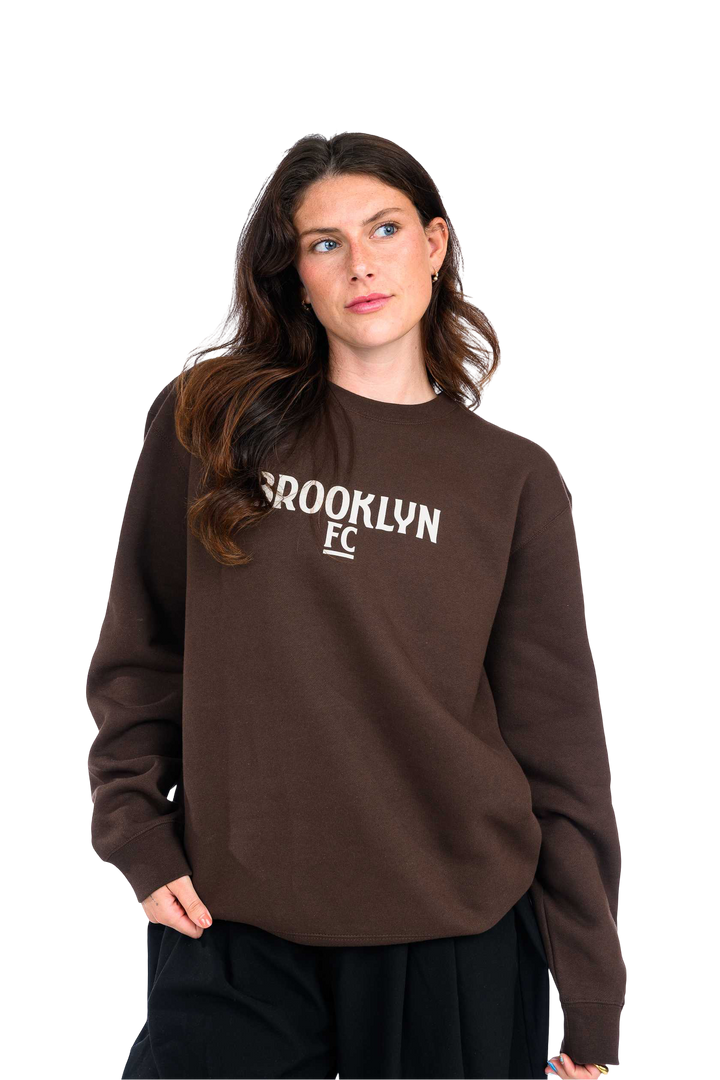 Brooklyn FC Logo Crewneck Sweatshirt in brown – Soft cotton-blend sweatshirt with ribbed cuffs, classic fit, and bold embroidered Brooklyn FC logo. Perfect for everyday wear.