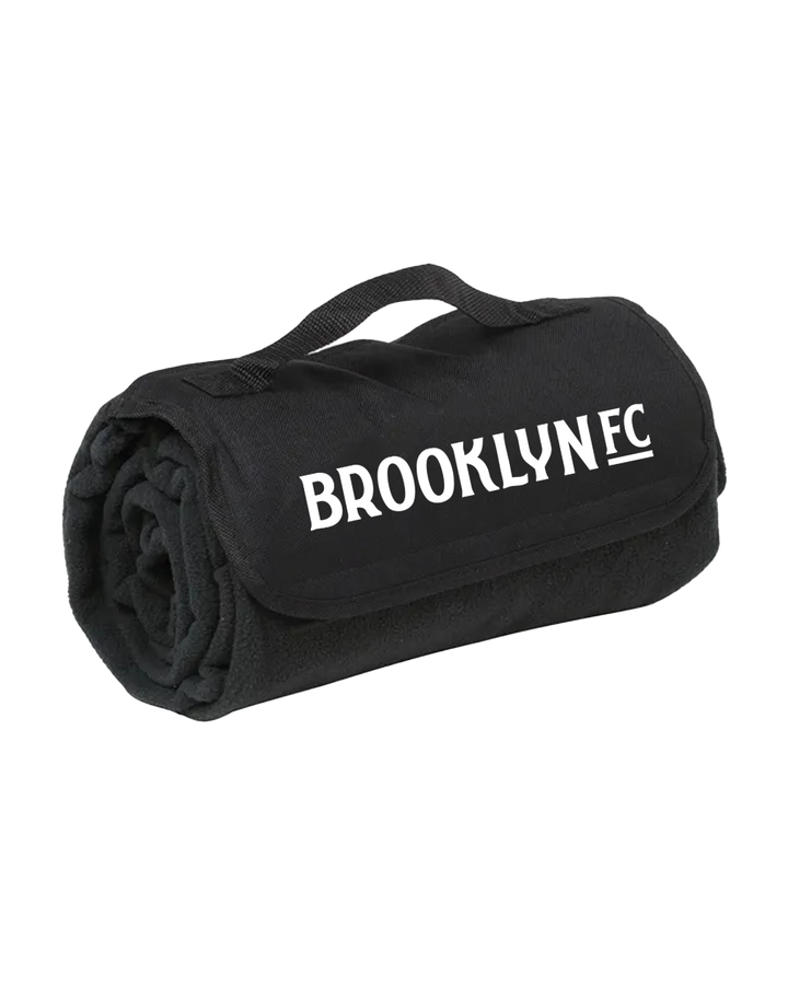 Rolled black Brooklyn FC stadium blanket with carry handle and printed logo.