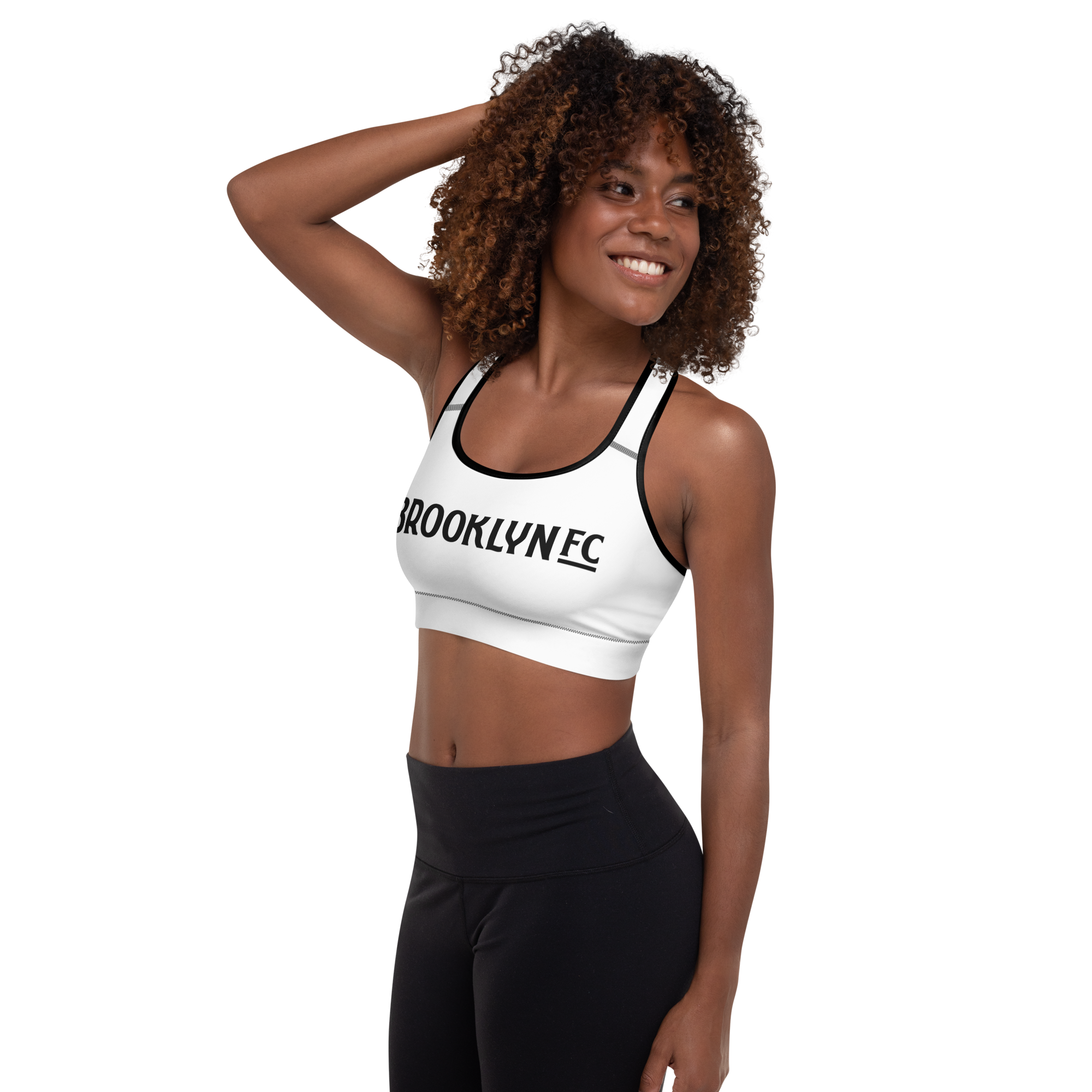 Brooklyn FC black padded sports bra with racerback, removable perforated foam padding, mesh lining, and wide under-bust elastic.