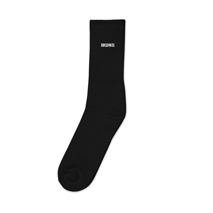 Pair of Brooklyn FC mid-calf socks in cotton-polyester-spandex blend with cushioned sole, embroidered crest, and logo-watermark soles.