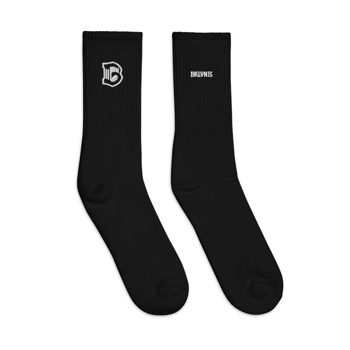 Pair of Brooklyn FC mid-calf socks in cotton-polyester-spandex blend with cushioned sole, embroidered crest, and logo-watermark soles.